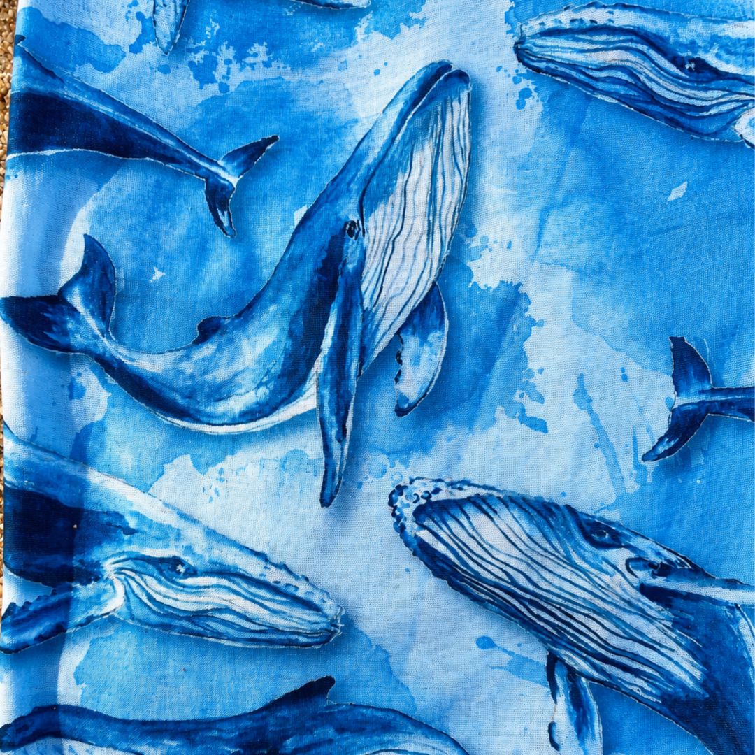Artistic depiction of whales on a blue textured background