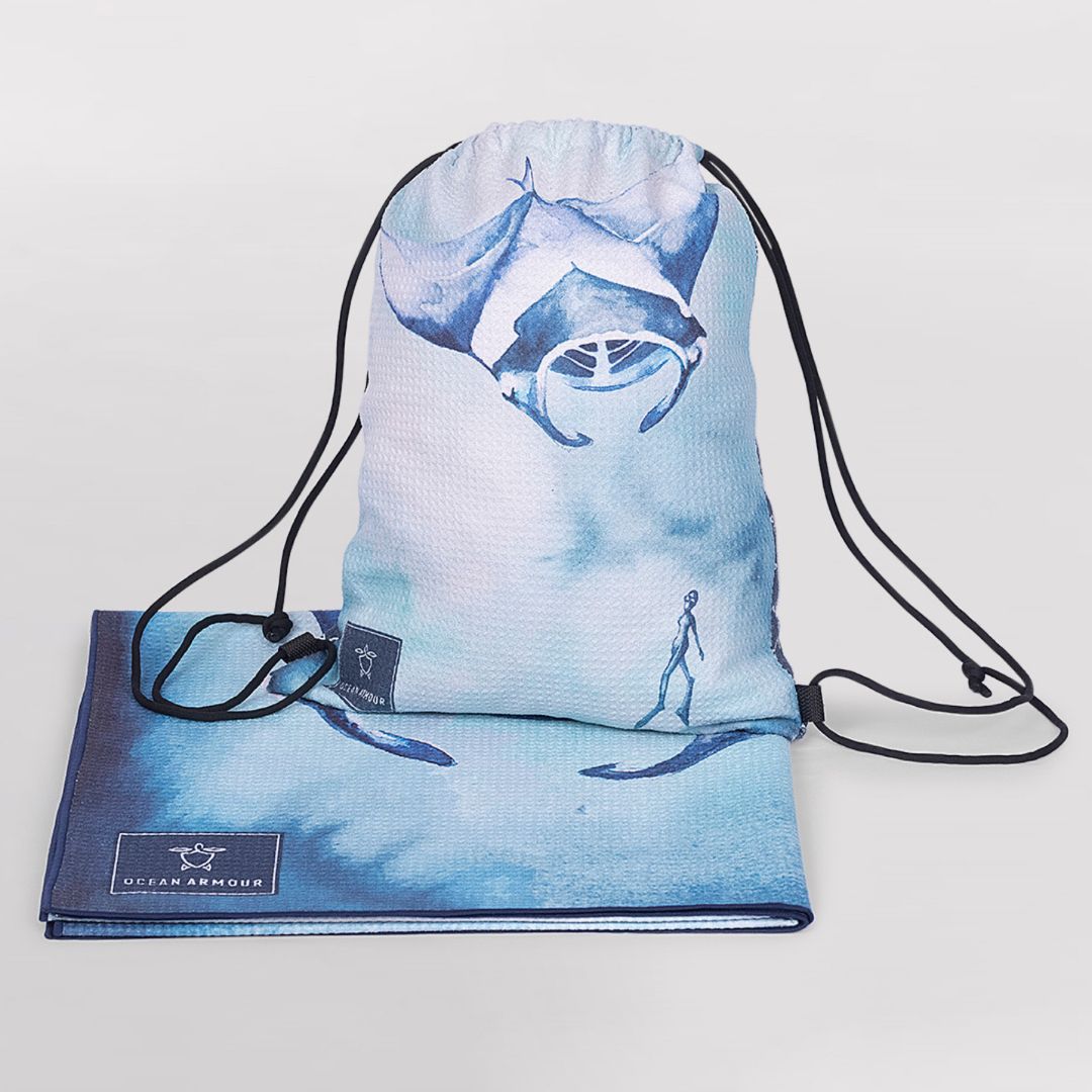 Ocean Armour Manta Ray drawstring beach bag displayed with a matching Manta Ray quick-dry beach towel on a white background.