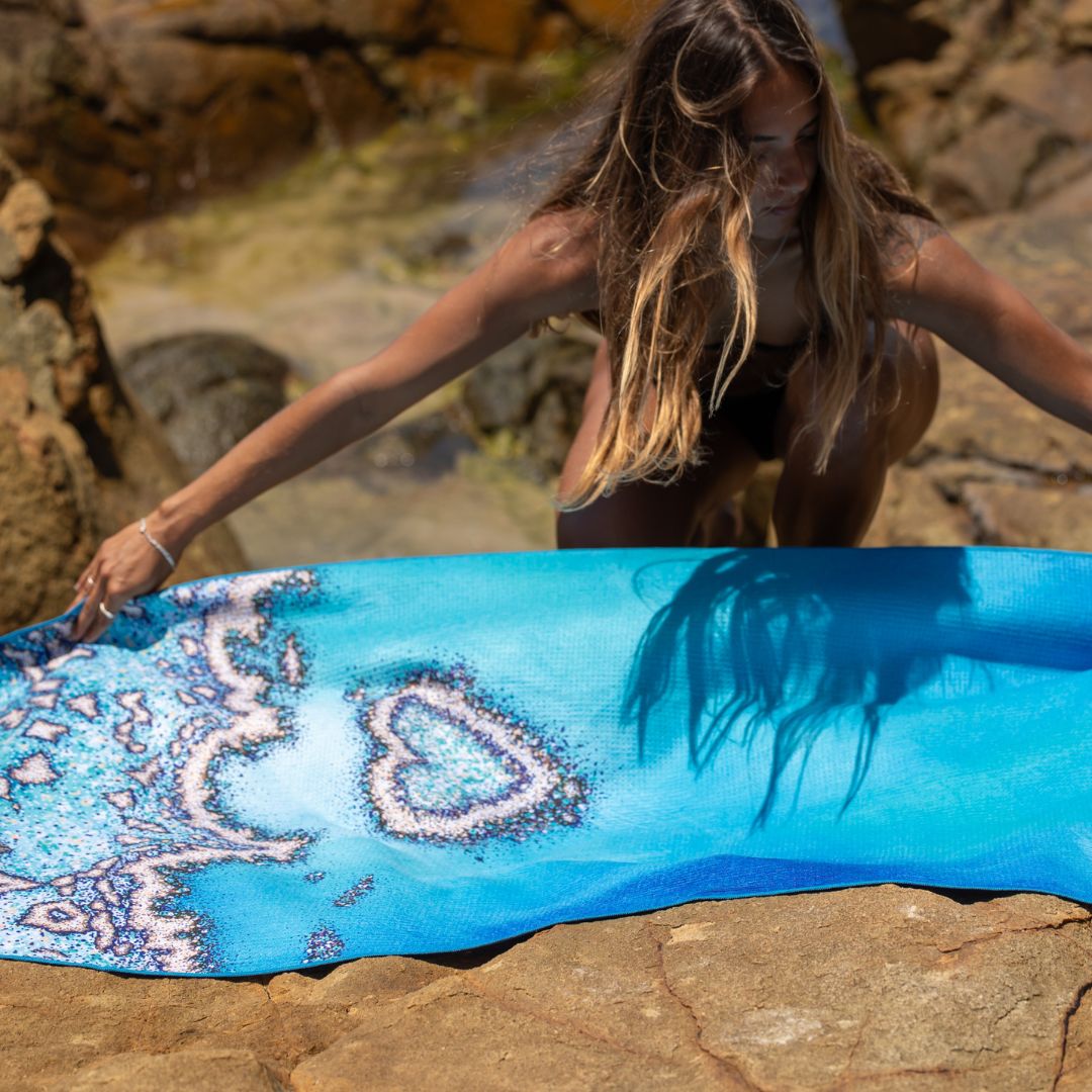 Eco-friendly Reef Love microfiber beach towel featuring a blue coral pattern,