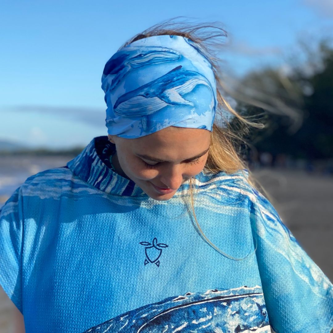 Person wearing a blue patterned headband and matching shirt outdoors