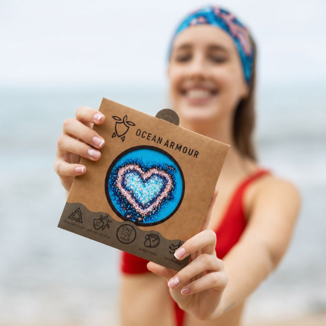 Person holding a 'Ocean Armour' product packaging with a heart design.